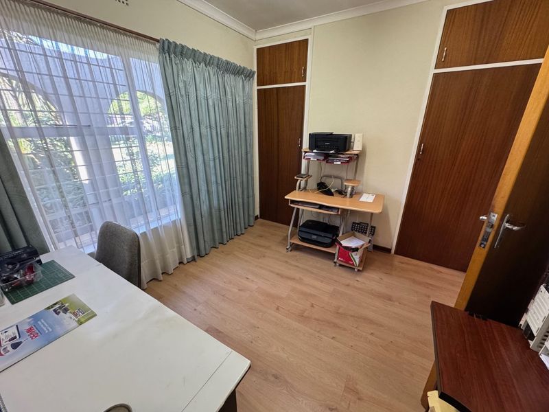 Elegant Four-Bedroom Home with Pool and Ample Storage - Photo 9