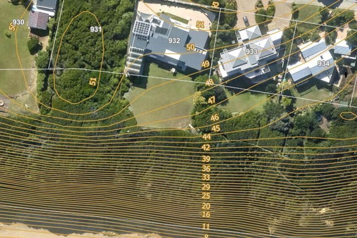Aerial view of residential plots featuring topographic contour lines and property boundaries, showing proximity to the coastline.