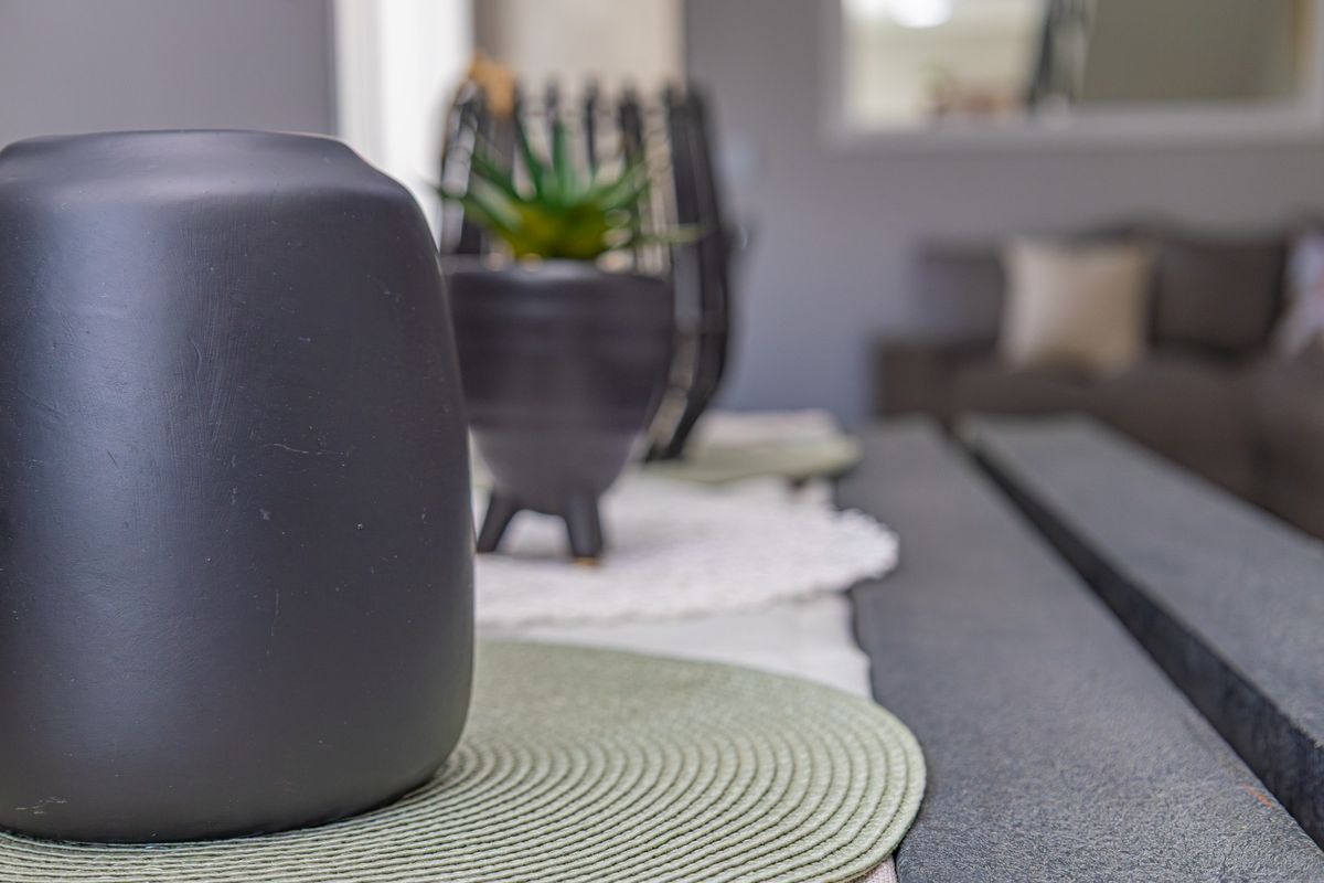 A close-up shot focusing on decorative items on a table within a living area, with the background intentionally blurred.