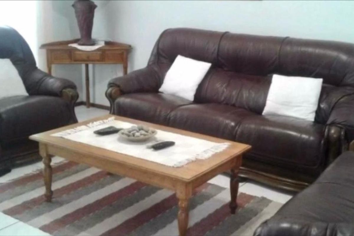 A living room area featuring tiled flooring and neutral wall finishes, providing a functional space for relaxation.