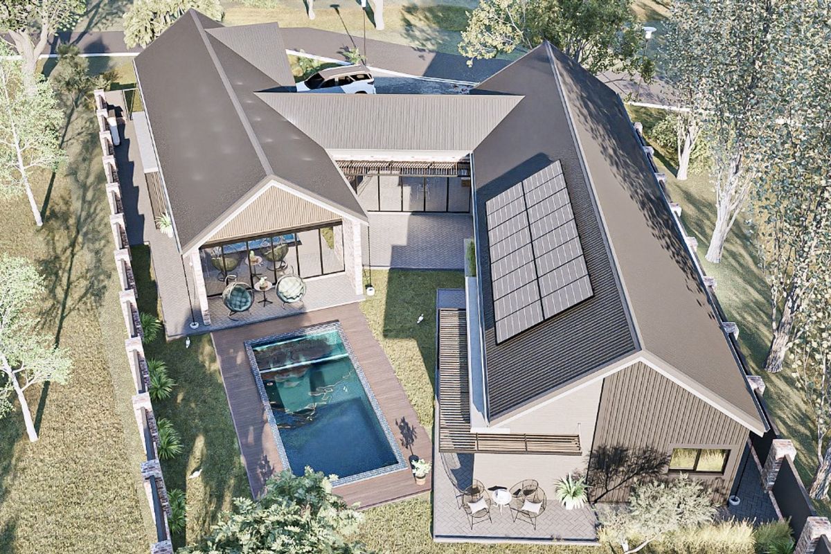 Aerial view of a modern residential property featuring a swimming pool, timber decking, and solar panels installed on a pitched metal roof.