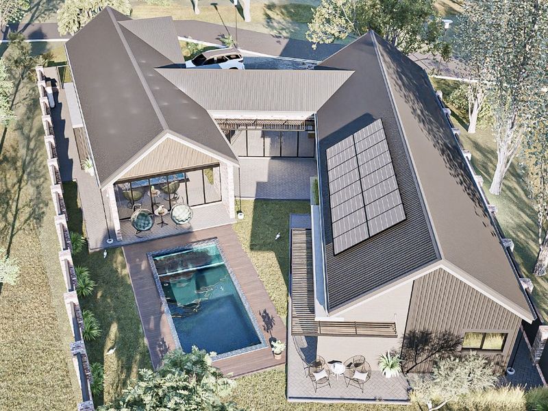 Aerial view of a modern residential property featuring a swimming pool, timber decking, and solar panels installed on a pitched metal roof.