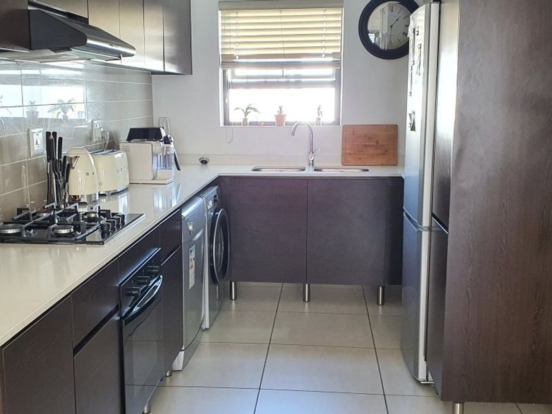 Modern 2-Bed, 2-Bath Gem with Appliances & Top-Tier Security in Greenstone Ridge - Photo 2