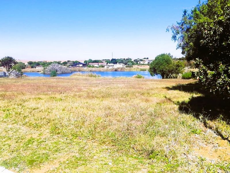 A scenic view of a tranquil lake and surrounding landscape, showcasing the natural beauty and open space of the residential land.