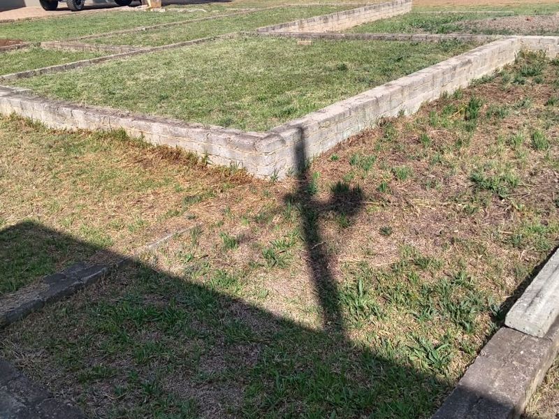 Vacant residential land featuring existing concrete foundation footings and established perimeter retaining walls, suitable for new construction.