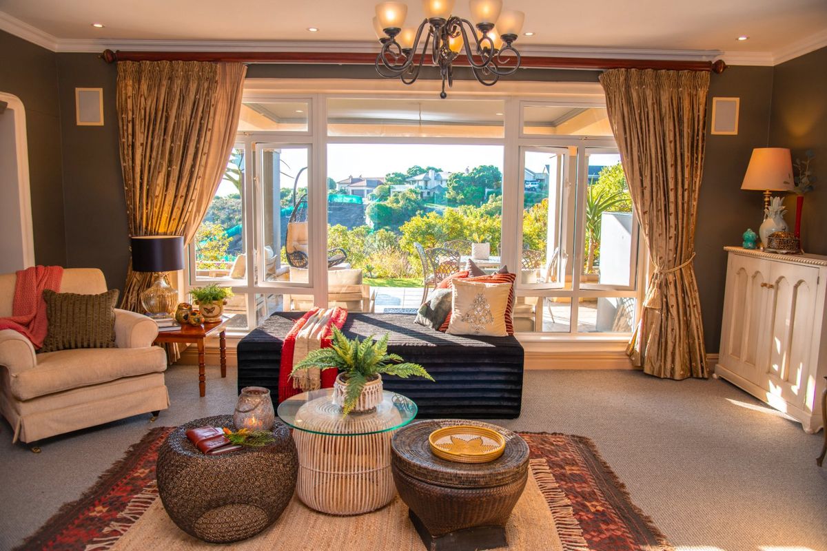 A well-maintained living room featuring large glass doors that provide natural light and access to an outdoor patio area.