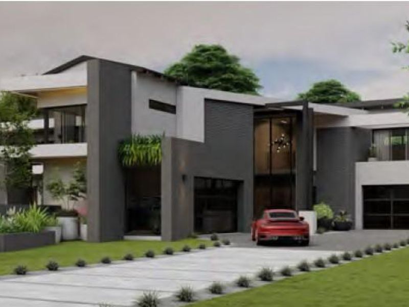 A modern, multi-level architectural home featuring a striking dark and light facade, double garages, and a well-manicured front garden with a paved driveway.