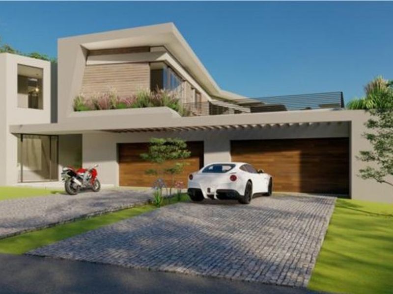 Modern architectural front elevation featuring a double garage with timber doors, a paved driveway, and an upper-level balcony with metal railings.