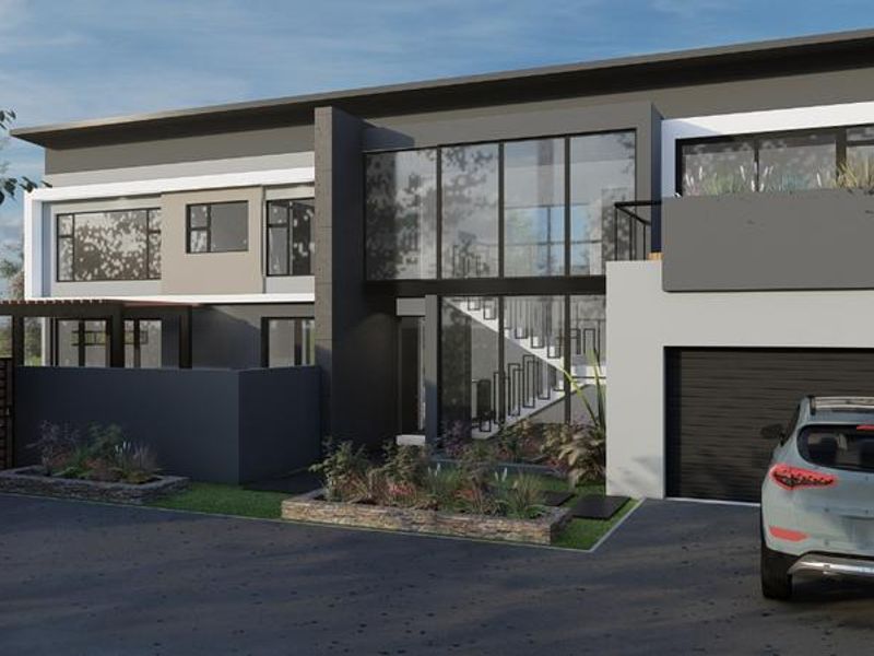 Modern double-story residential facade featuring a large glass entrance, contemporary flat roof design, and a paved driveway with integrated garden beds.