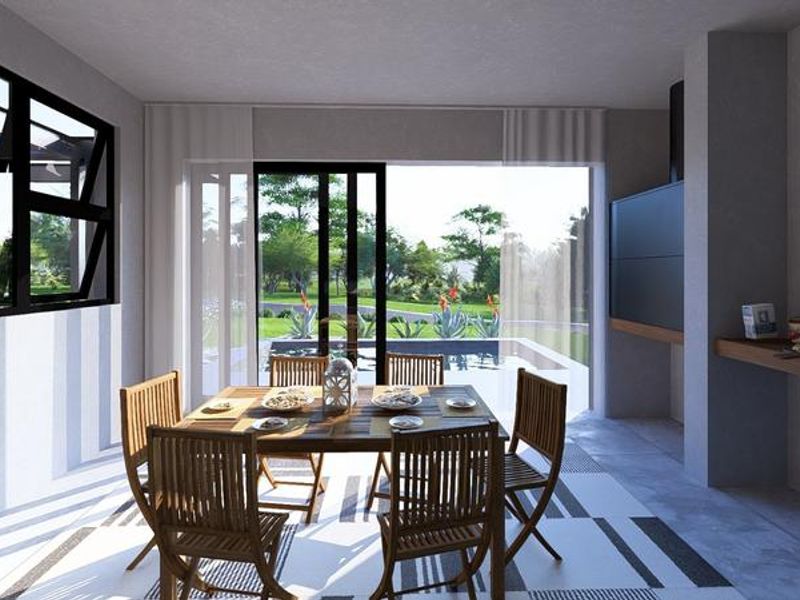 A modern covered patio featuring a built-in fireplace, large sliding glass doors, and seamless access to the outdoor pool area.
