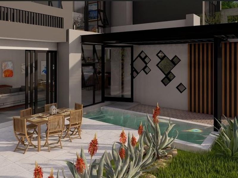 Modern outdoor living area featuring a sleek plunge pool, covered patio with bi-fold doors, and contemporary timber slat architectural detailing.