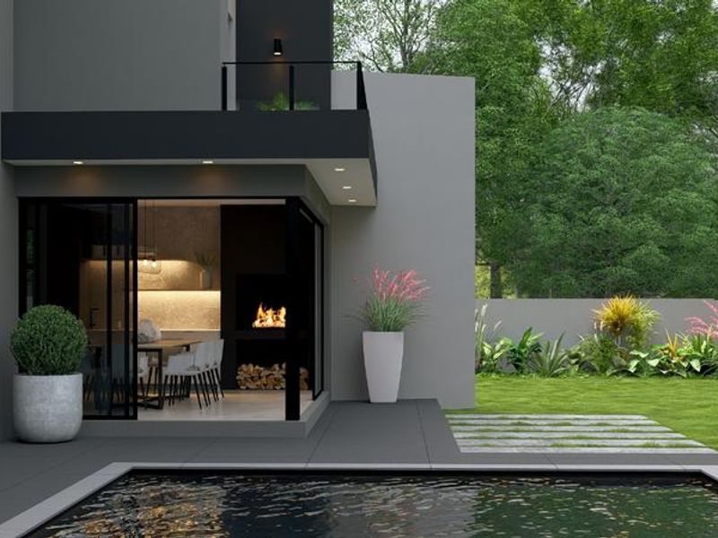 Modern outdoor entertainment area featuring a swimming pool, tiled patio, and a covered space with a built-in fireplace overlooking a landscaped garden.