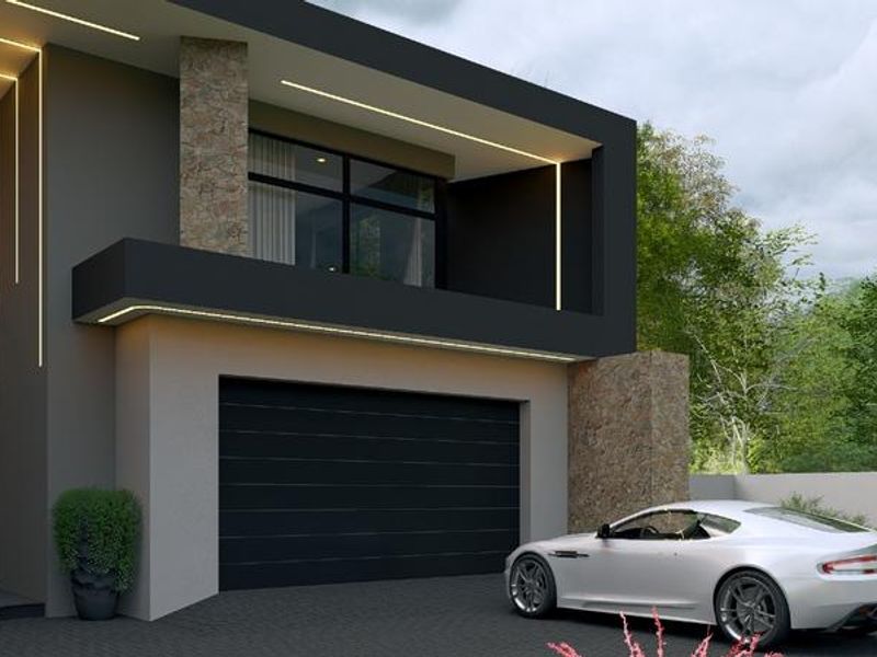 Modern architectural front facade featuring stone cladding, integrated LED lighting, a large glass entrance, and a sleek garage door.