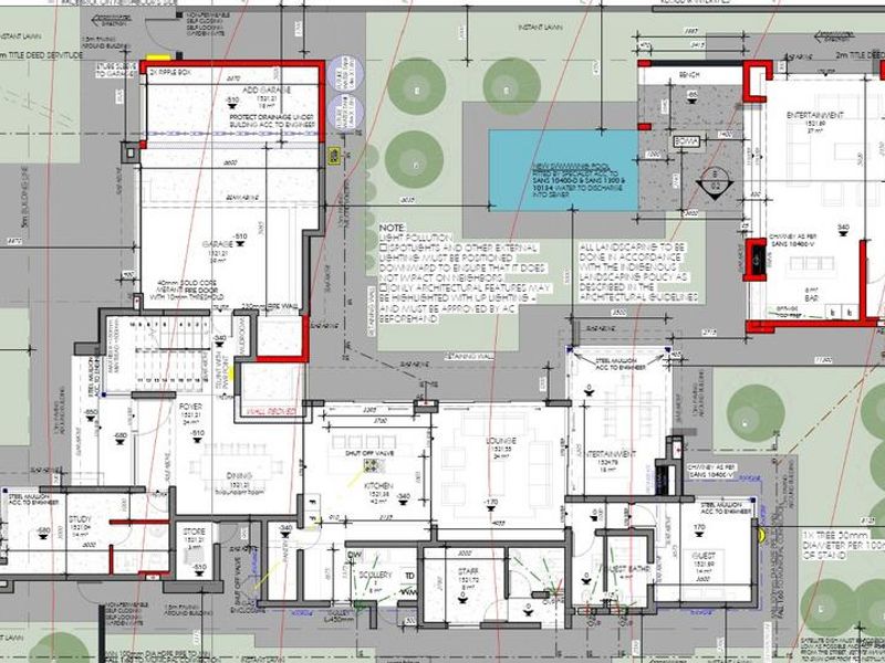 A detailed architectural floor plan showing the layout of the house, including living areas, kitchen, garage, and outdoor entertainment spaces.