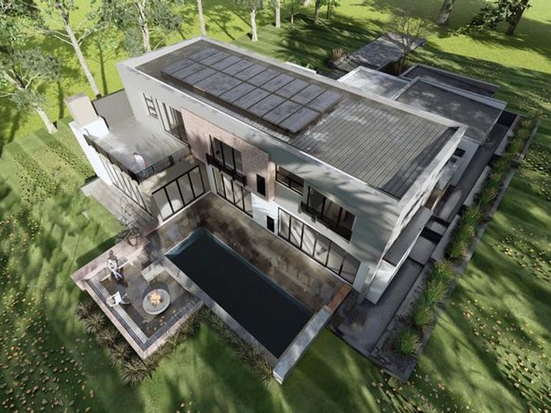 Aerial view of a modern multi-story residence featuring a flat roof with solar panels, a swimming pool, and a paved patio area.