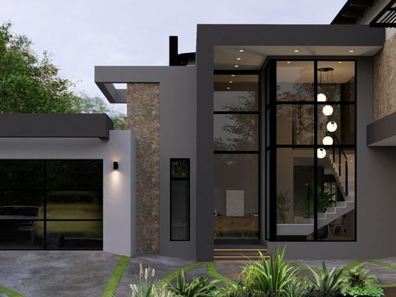 Modern architectural front elevation featuring stone cladding, expansive glass windows, and a contemporary paved driveway with integrated lighting.
