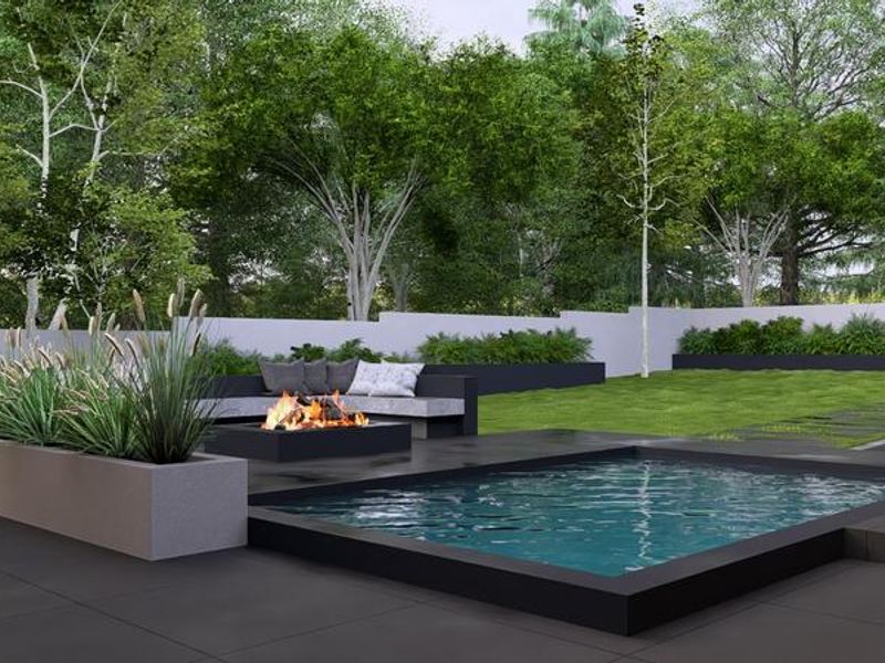 Modern outdoor pool area featuring a sleek swimming pool, built-in fire pit, and landscaped garden with concrete planters and tiled patio.