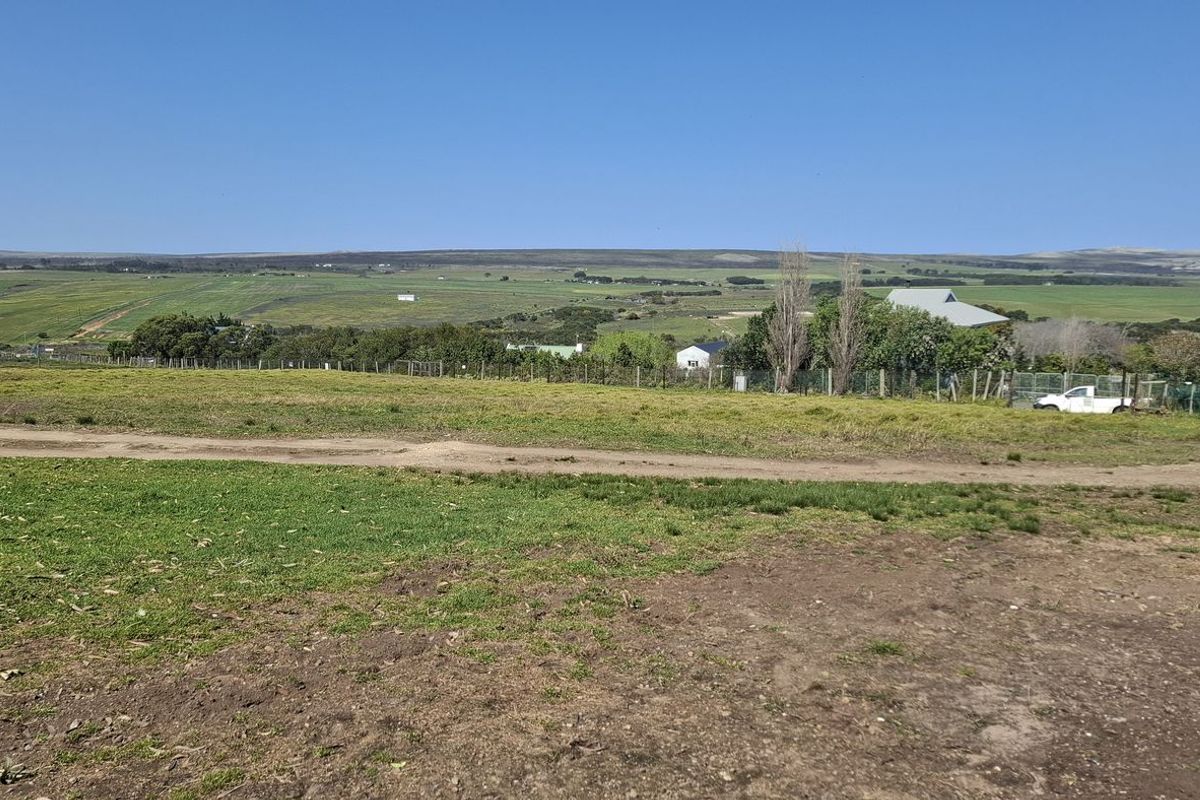 A wide-angle view of the vacant residential land, showcasing the surrounding rural landscape and open terrain.