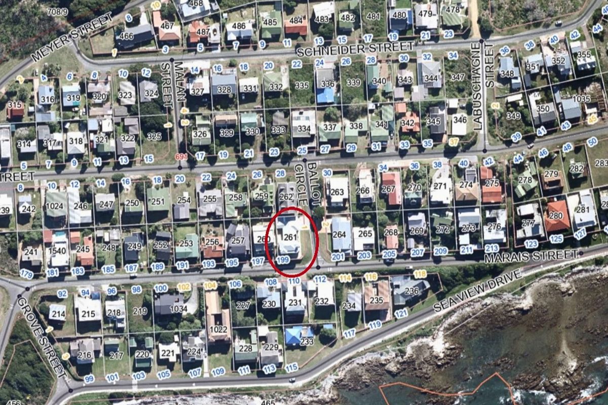 An aerial view of the residential property located within a coastal neighborhood, highlighting its position and surrounding street layout.