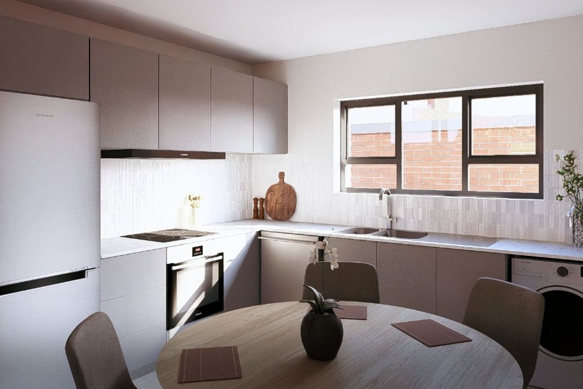 Modern kitchen featuring sleek cabinetry, integrated oven, hob, extractor fan, and a double sink, with a dedicated space for a washing machine.