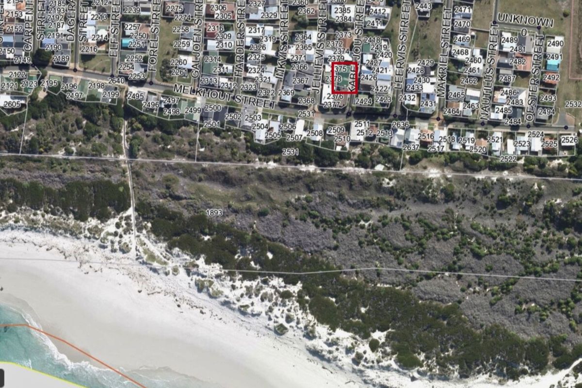 Aerial view of the property location highlighting the plot boundaries in relation to the surrounding coastal neighbourhood and beach access.