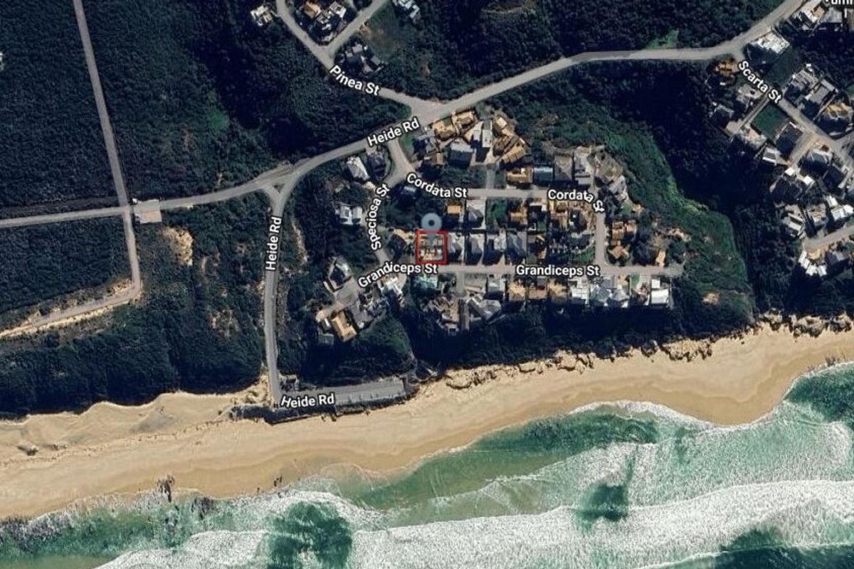 An aerial satellite view showing the property location within a coastal residential neighborhood near the beach.