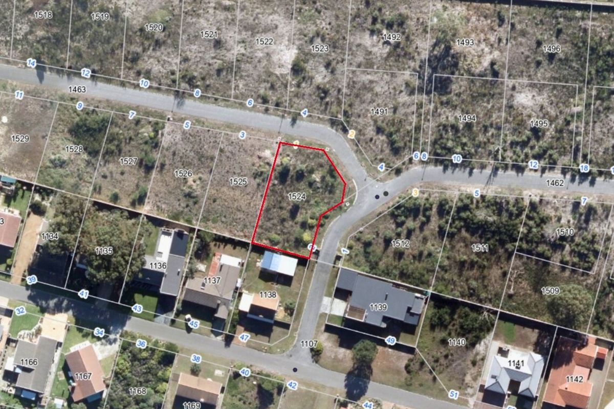 An aerial view of a vacant residential plot, identified as lot 1524, situated within a developed suburban street layout.