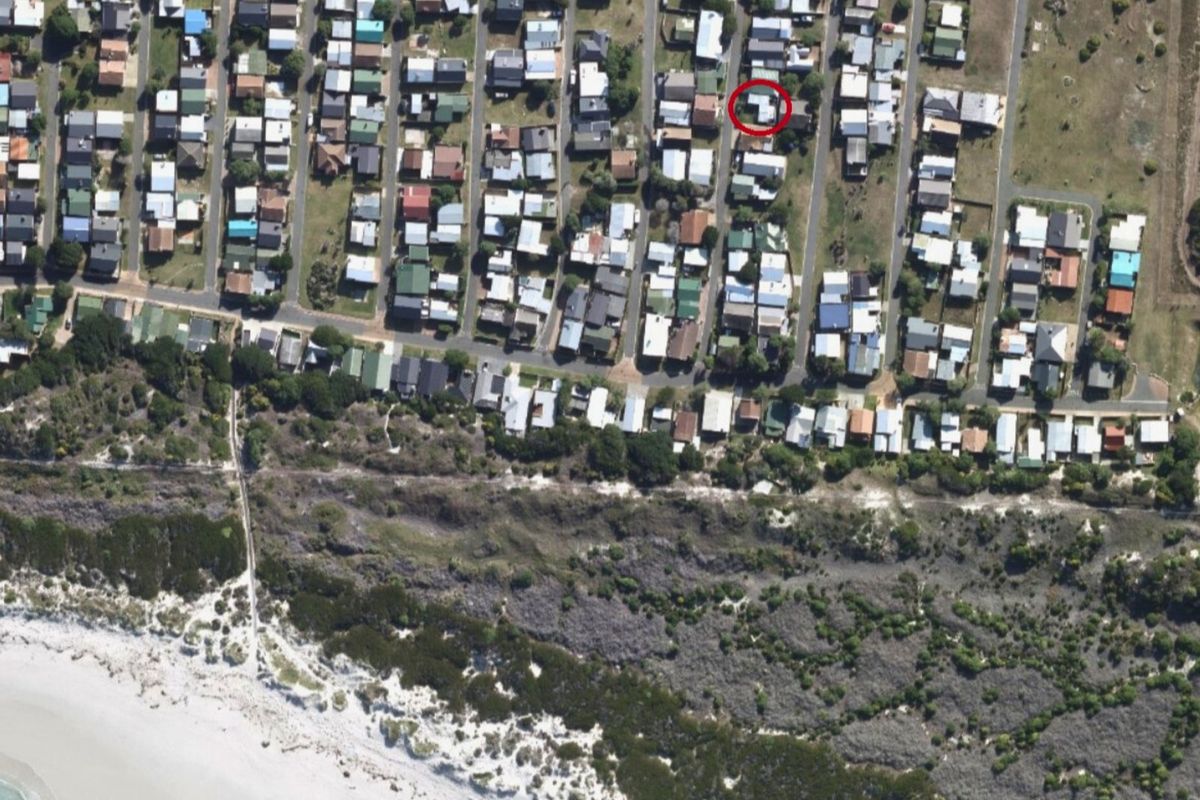 Aerial view of the coastal residential neighborhood showing the property location in relation to the beach and surrounding infrastructure.