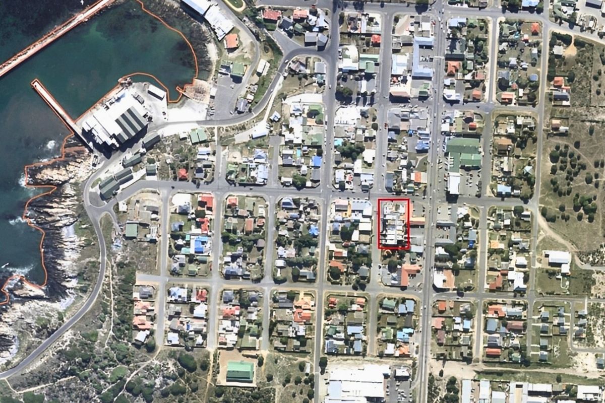 Aerial view of the coastal neighborhood showing the property location highlighted within the urban grid near the harbor.