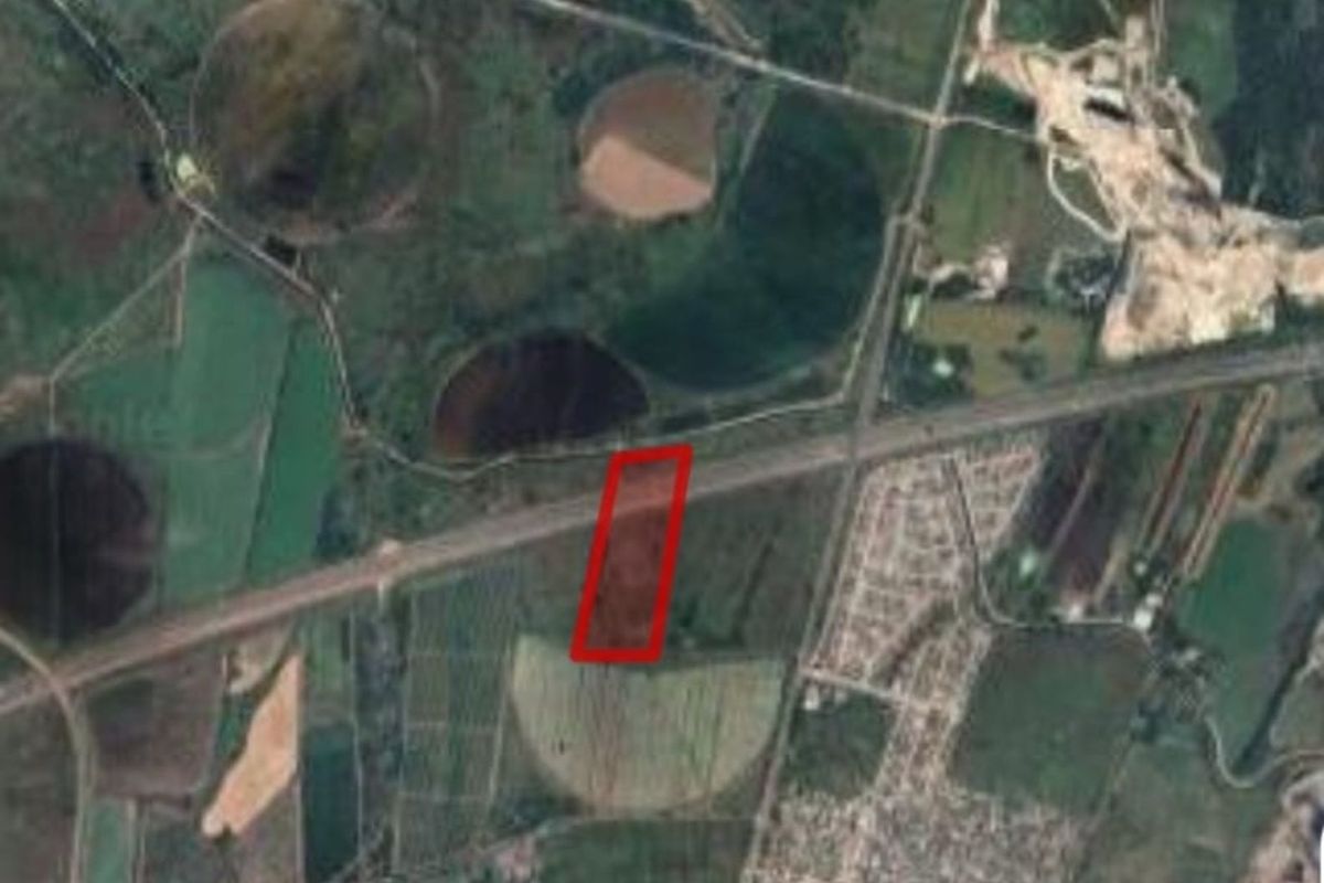 An aerial satellite view of the farm property, highlighting the land boundaries and surrounding agricultural landscape.