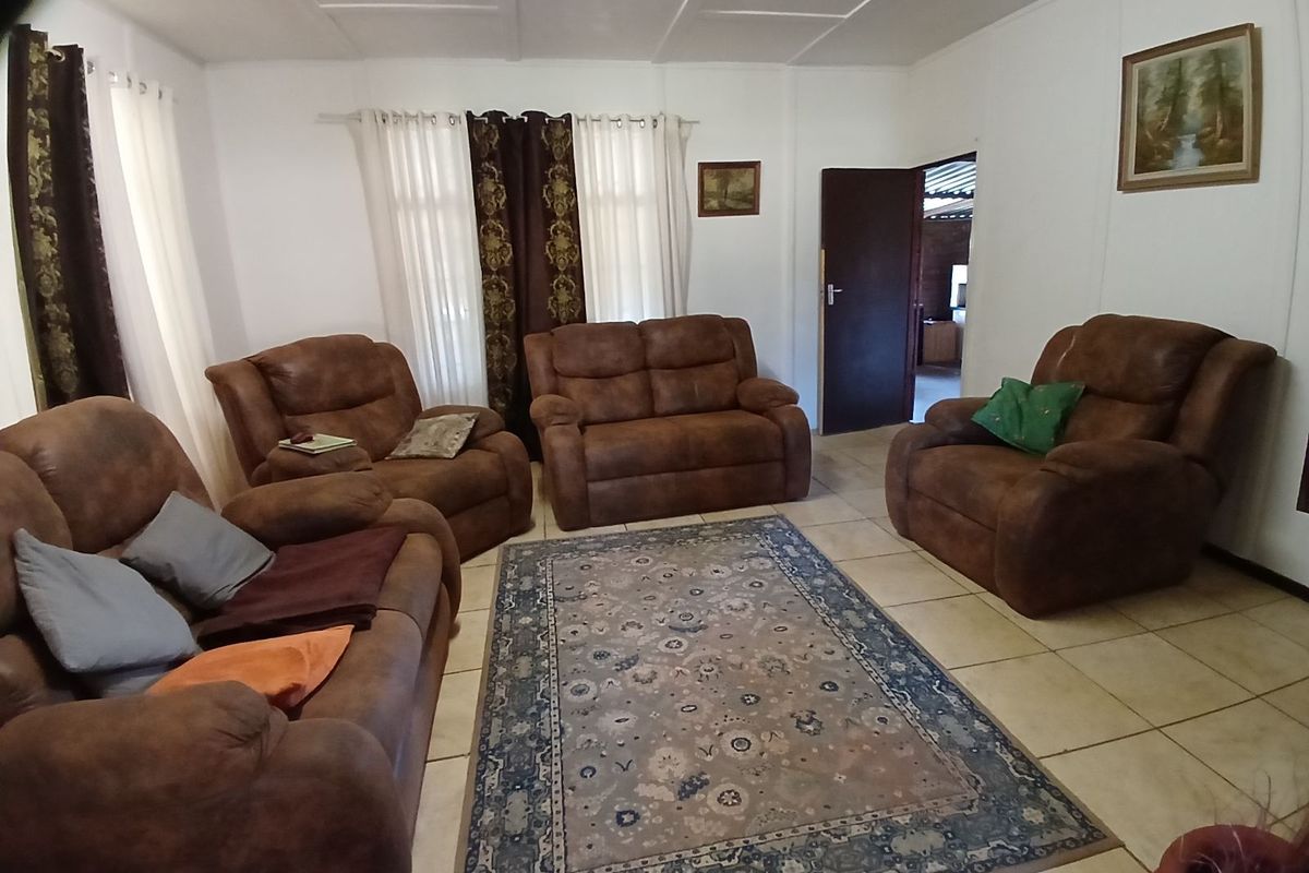 A comfortable living room featuring tiled flooring and neutral walls, providing a functional space for relaxation.
