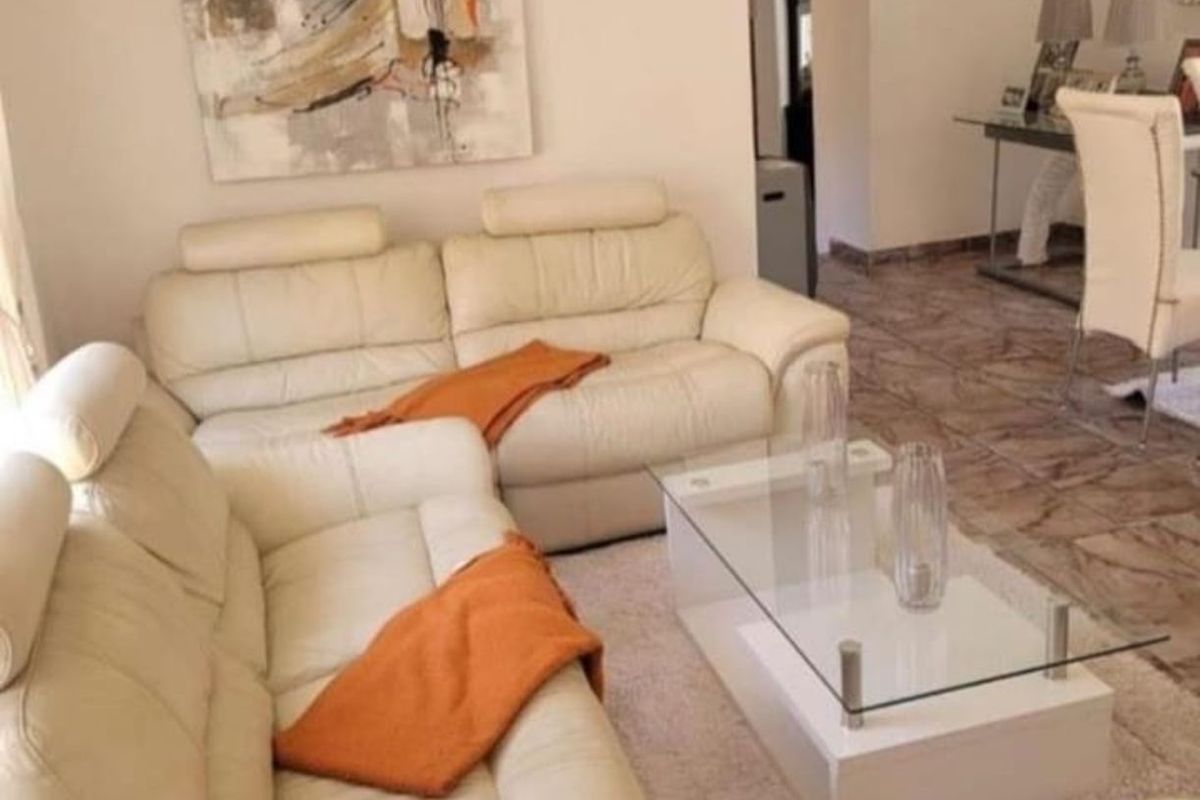 A comfortable living area featuring tiled flooring and neutral wall finishes, providing a functional space for relaxation and daily living.
