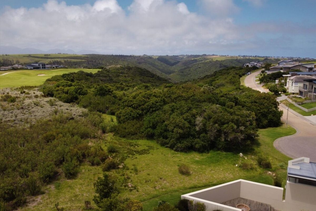 Aerial view of the vacant residential land featuring natural vegetation, surrounding landscape, and proximity to established estate infrastructure.