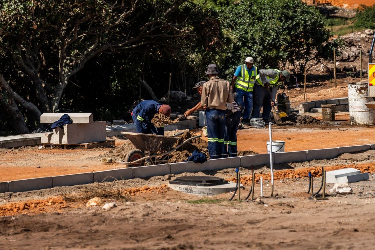An active construction site showing ongoing ground works, kerbing installation, and infrastructure development on the property grounds.