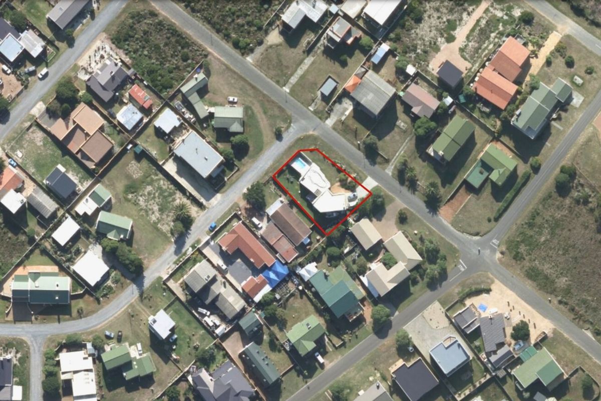 Aerial view of the property highlighting the residential plot, building footprint, and swimming pool within the surrounding neighborhood context.