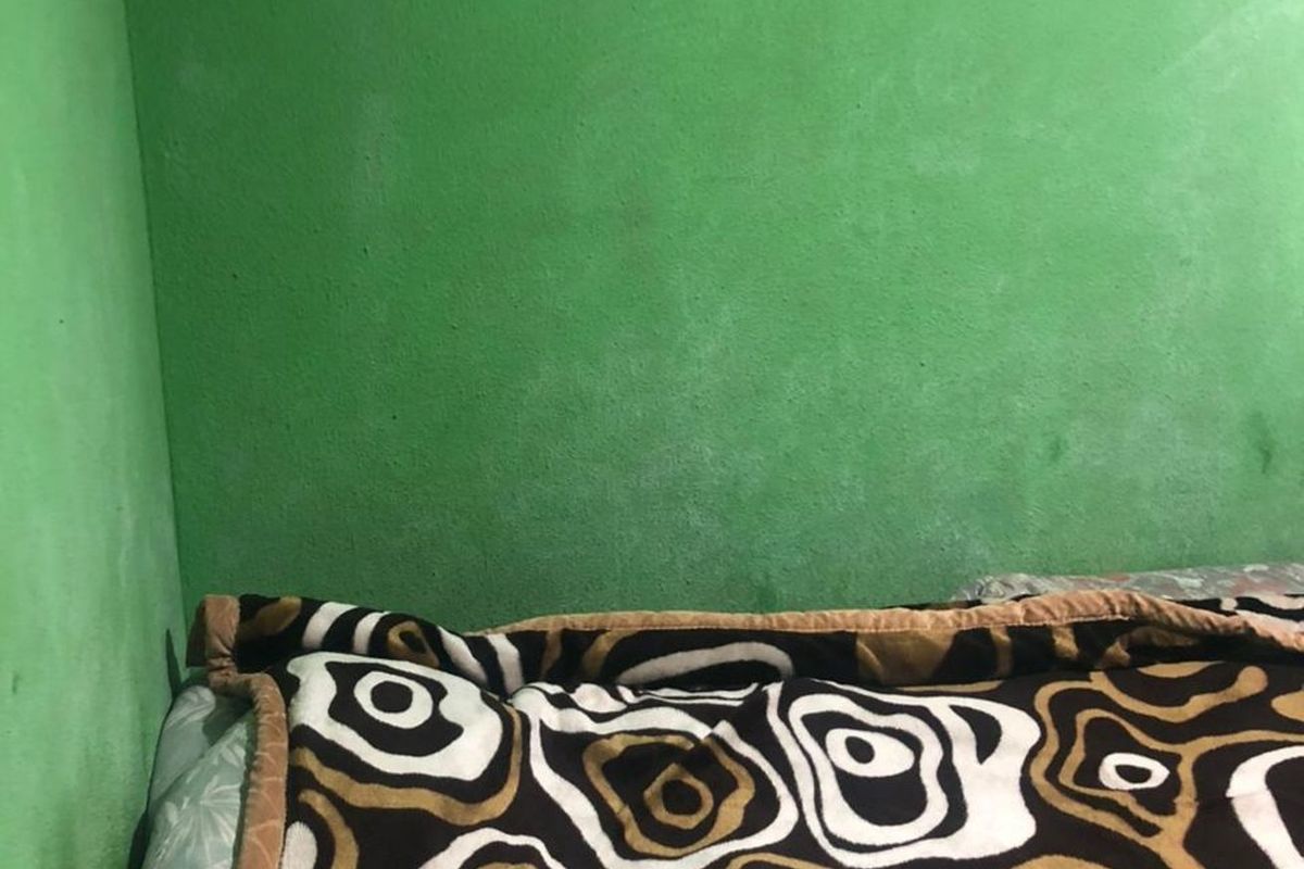 A bedroom corner featuring bright green painted walls.
