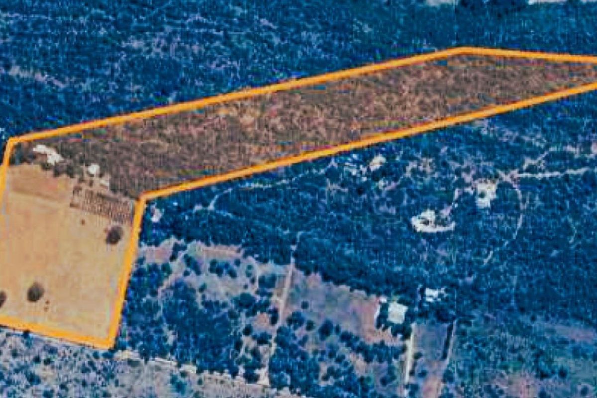 An aerial view of the farm property, highlighting the land boundaries and surrounding landscape.