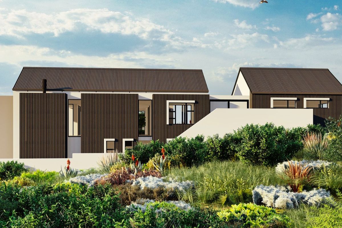 A modern architectural exterior view of a contemporary house featuring dark vertical cladding, pitched roofs, and landscaped native garden surroundings.