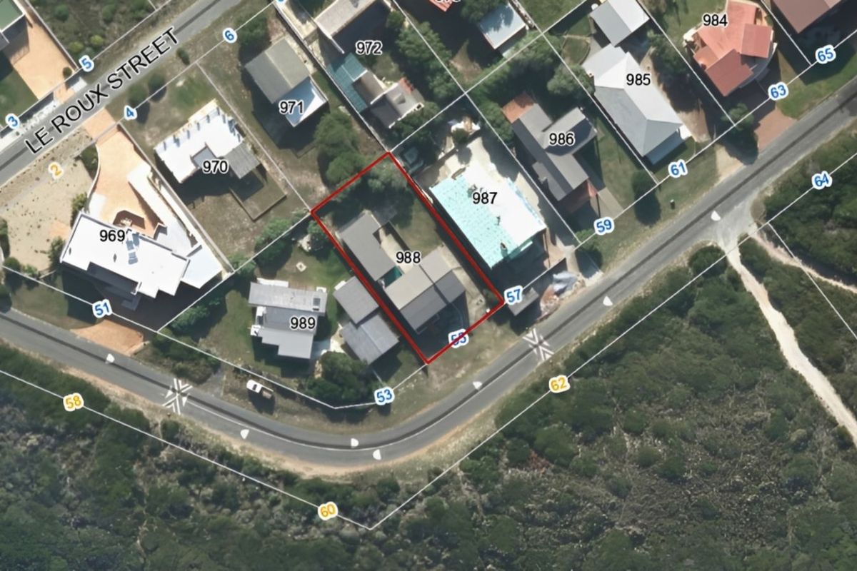 Aerial view of the property located at 988, showing the building footprint, surrounding plot, and proximity to the coastal road and neighborhood.