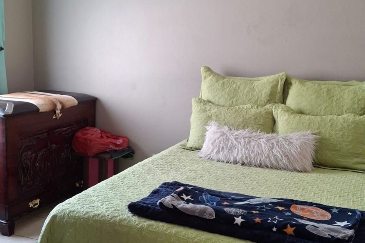 A bedroom featuring tiled flooring and neutral wall finishes.