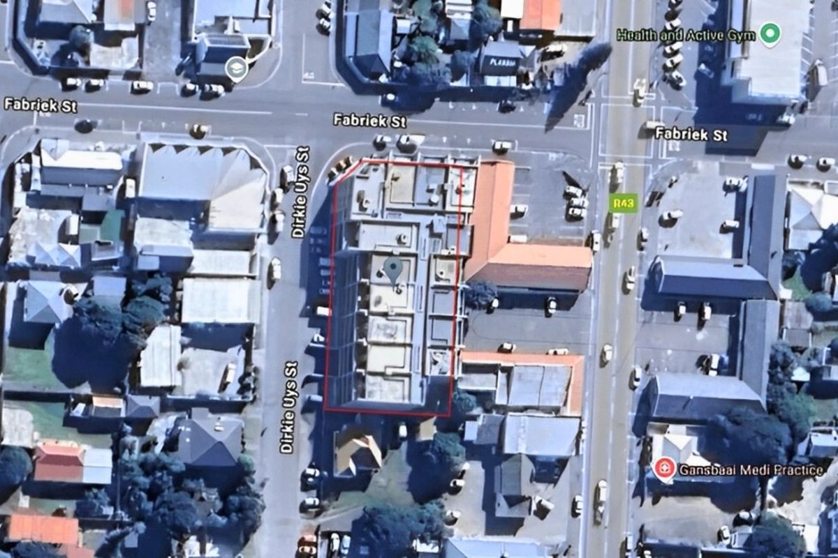 Aerial view of the apartment building location, highlighting its position within the surrounding urban street network and local infrastructure.