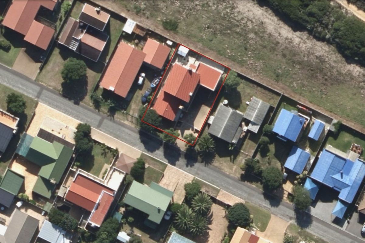 Aerial view of the residential property showing the house footprint, roof structure, and surrounding garden area within the neighborhood context.