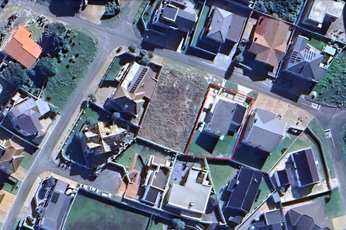 Aerial view of the residential property highlighting the building footprint and surrounding plot layout within the neighborhood.