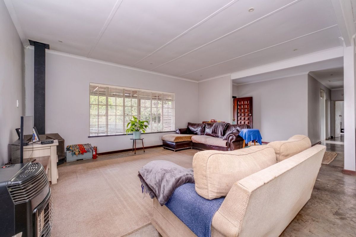 Spacious living room featuring a built-in fireplace, large windows, and neutral wall finishes, offering a comfortable and functional area for relaxation.