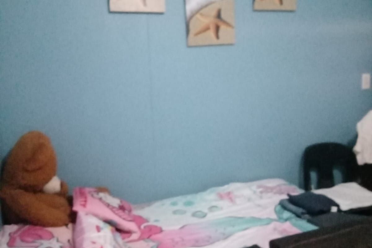 A bedroom featuring blue painted walls and a standard layout, suitable for a single bed setup.