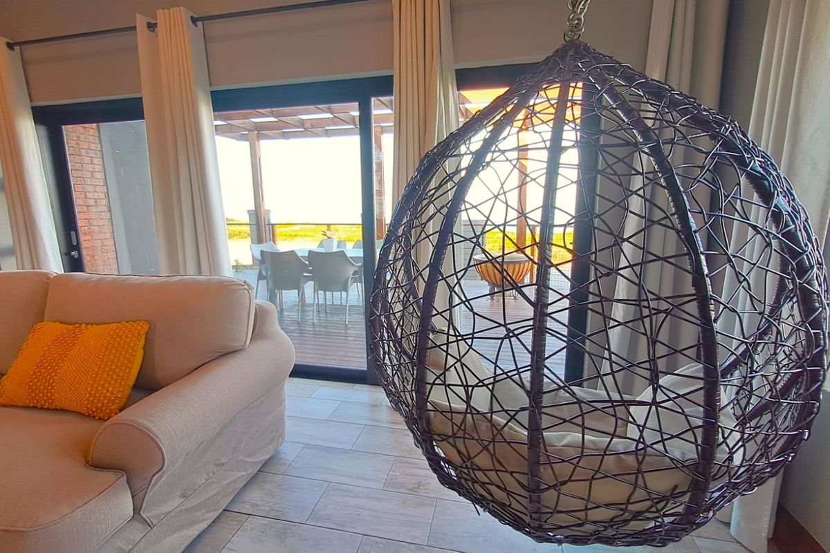 Spacious living area featuring large sliding glass doors that open onto a covered outdoor patio, providing seamless indoor-outdoor flow and natural light.