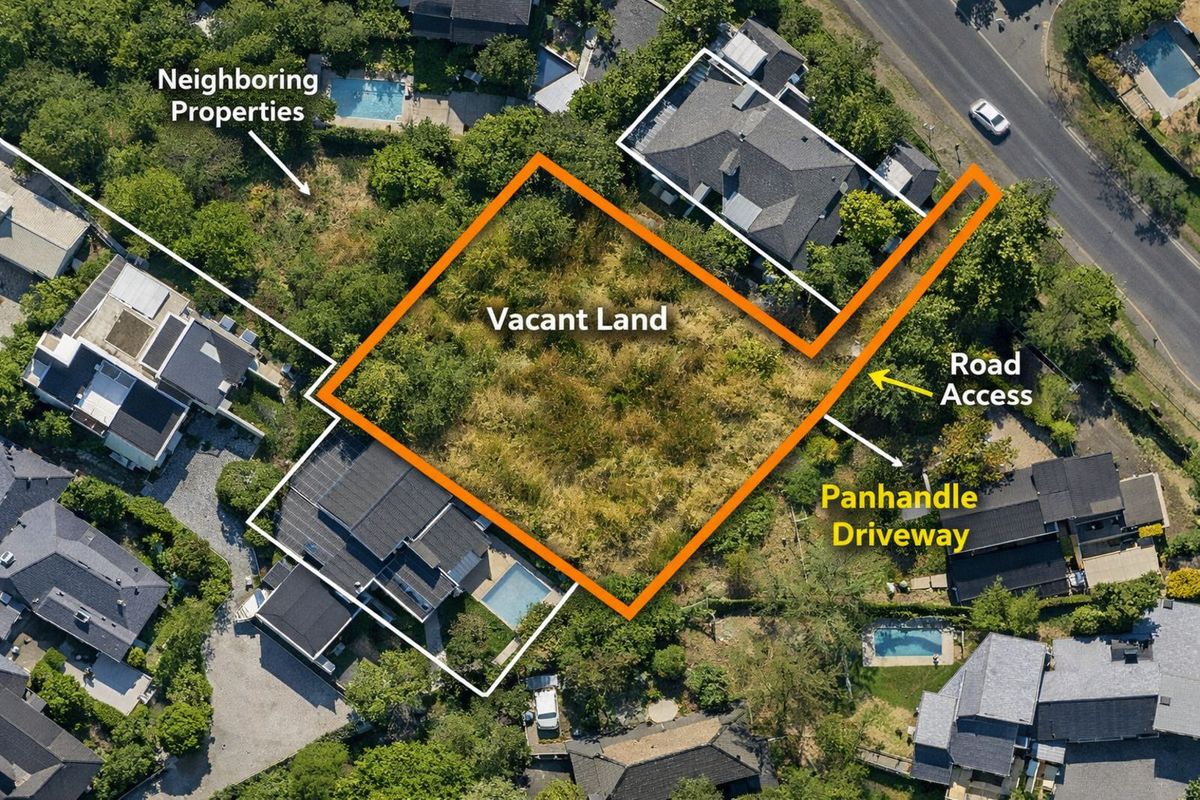 Aerial view of a vacant residential plot featuring a panhandle driveway providing direct road access within an established neighborhood.
