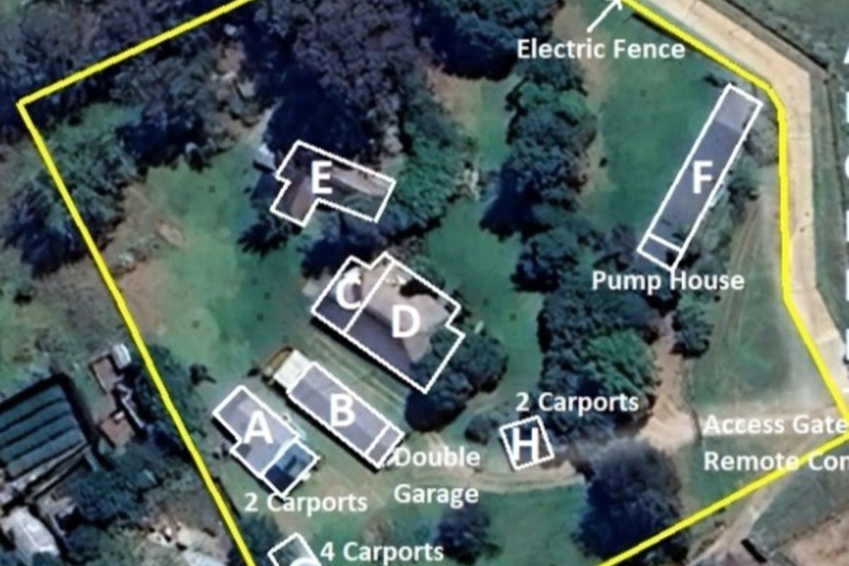 An aerial view of the property layout, highlighting various outbuildings, carports, a pump house, and perimeter electric fencing within the grounds.