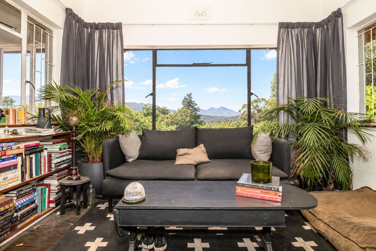 A cozy living room featuring large windows that frame scenic mountain views, providing ample natural light and a tranquil atmosphere.
