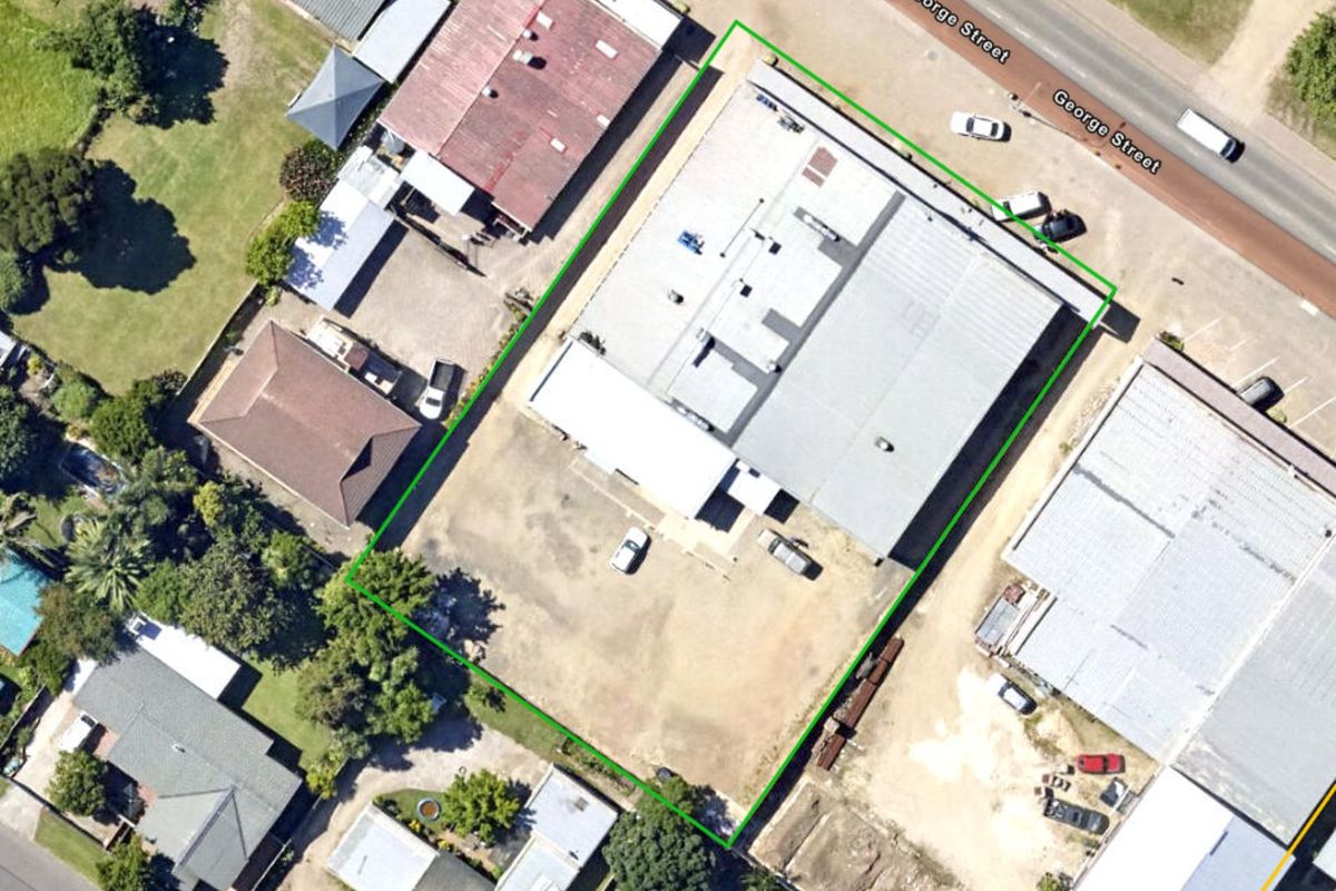 Aerial view of the commercial property site, highlighting the building footprint, surrounding yard space, and access from George Street.